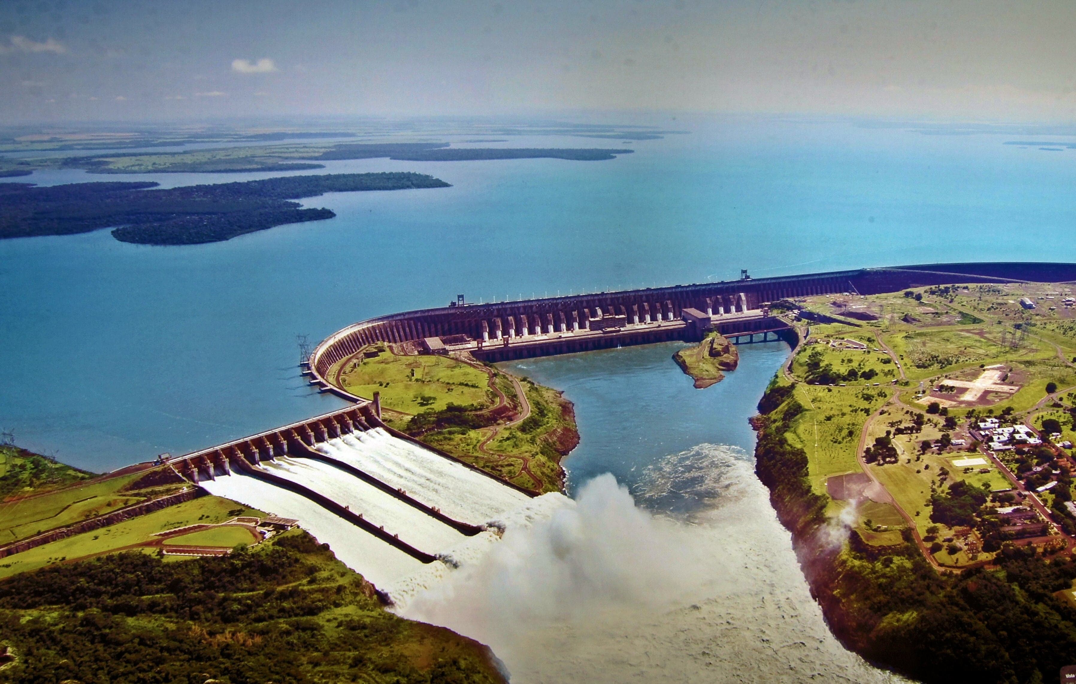 The enormous Itaipu Dam with water flowing through its spillways on the Paraná River