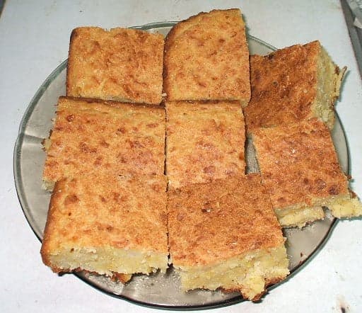 Golden slices of sopa paraguaya - a thick, dense cornbread - on a wooden board