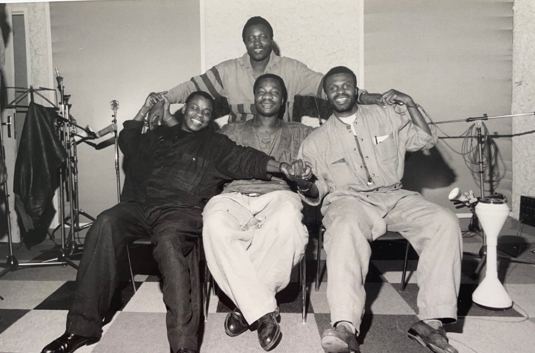 A Congolese soukous band performing on stage with electric guitars and dancers