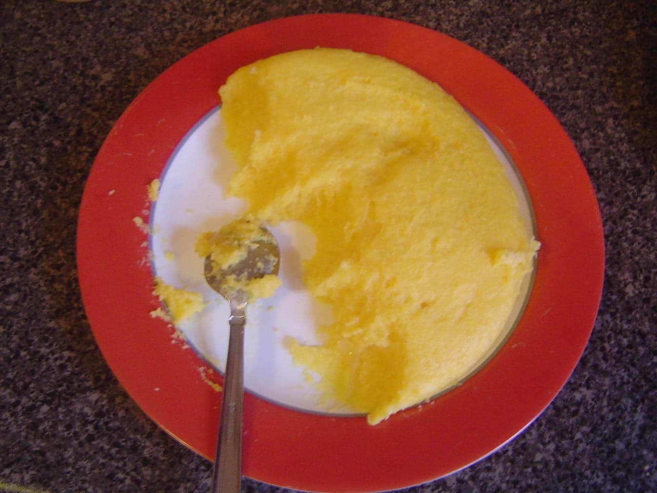 A bowl of mămăligă - thick yellow Romanian cornmeal porridge