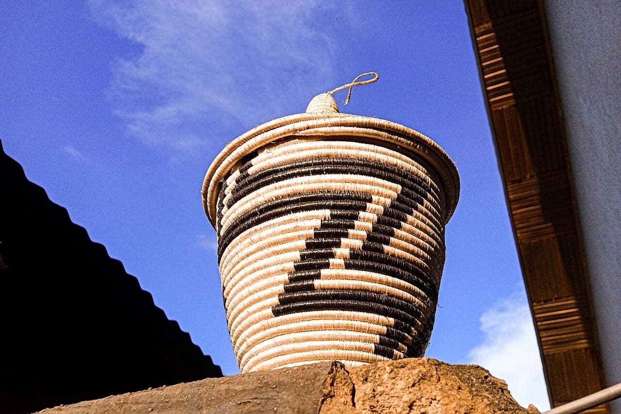 Brightly patterned woven Rwandan agaseke baskets with pointed lids