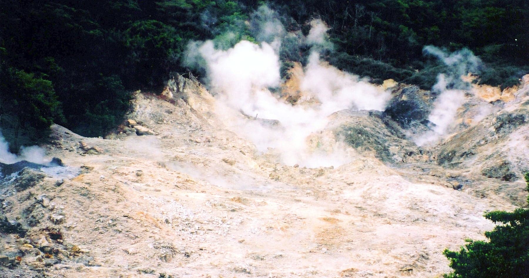 Steaming bubbling mud pools and yellow sulphur rocks at Sulphur Springs in Saint Lucia