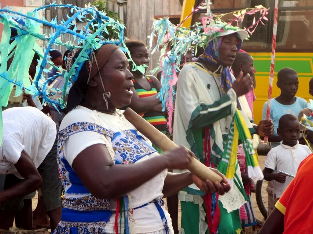 A group of singers in colourful traditional dress performing ússua on São Tomé