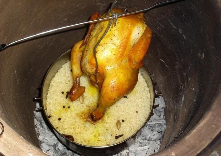 Mandi - tender meat with yellow rice on a large platter