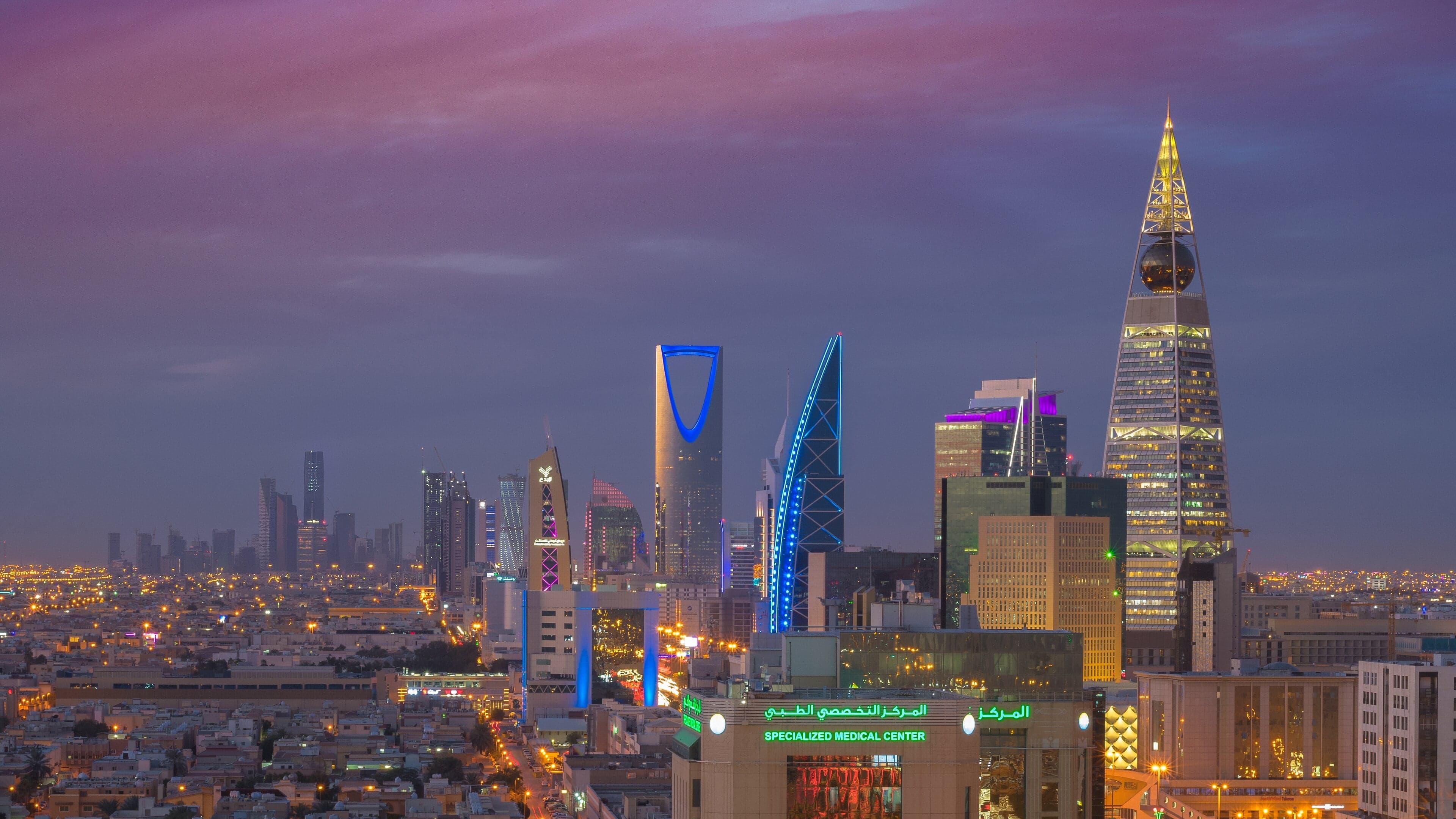 The Riyadh skyline at dusk with the Kingdom Centre tower