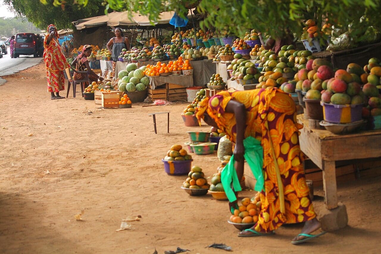 A Senegalese family sharing a meal together around a large platter