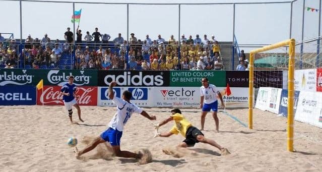 Young players competing in beach soccer on a Sierra Leonean white sand beach