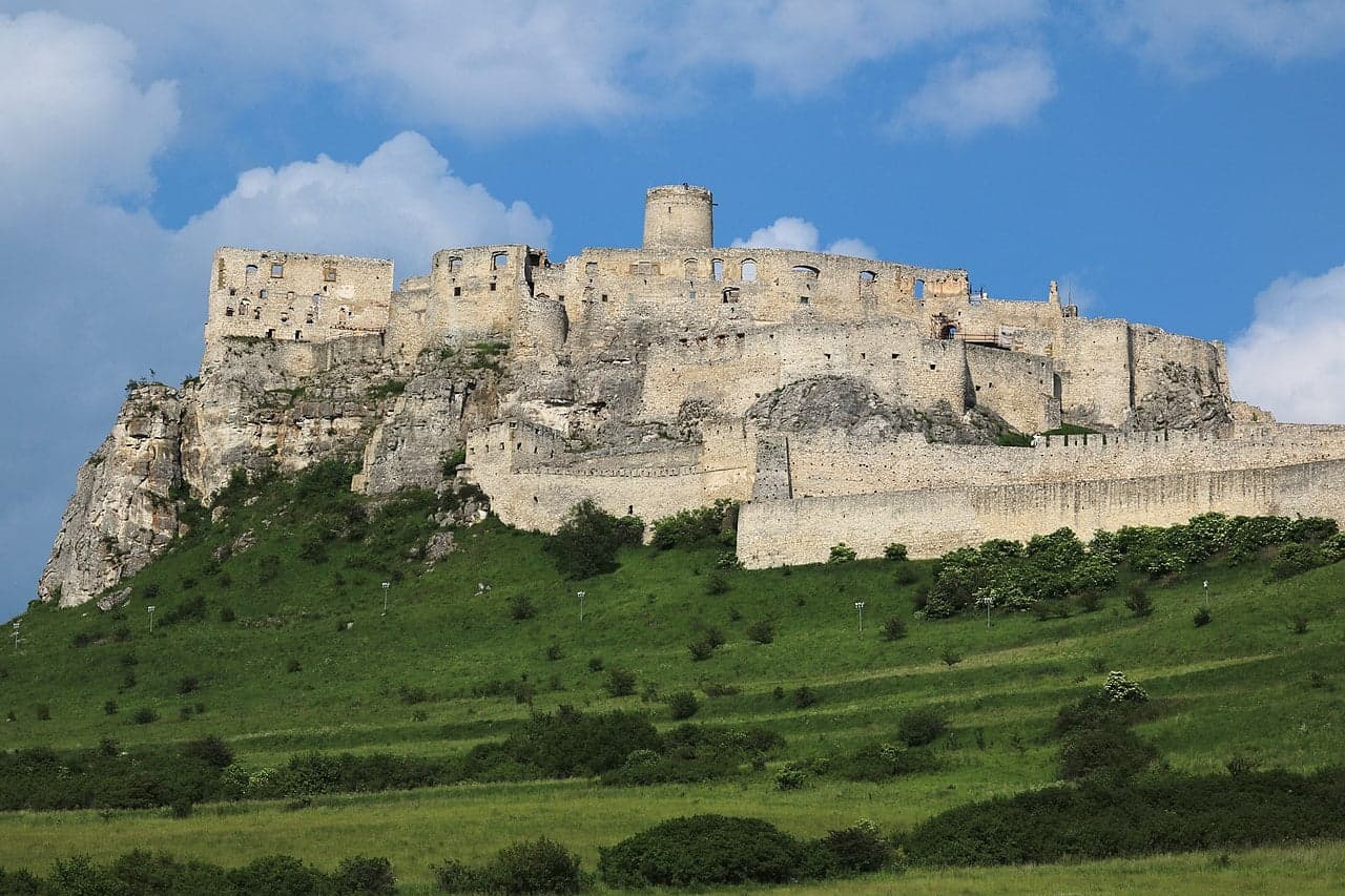 The huge ruined walls of Spiš Castle covering a green hill in eastern Slovakia