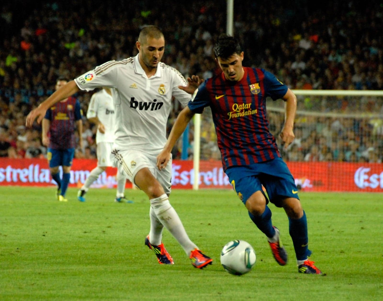 Players from Real Madrid and Barcelona competing for the ball during a match
