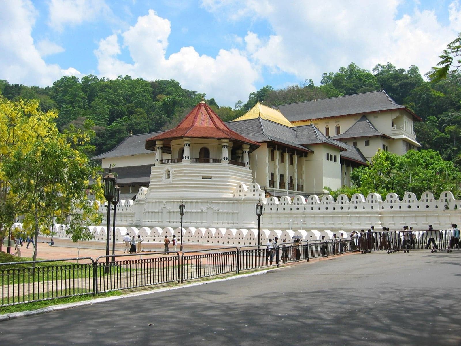 The white walls and golden roof of the Temple of the Tooth in Kandy