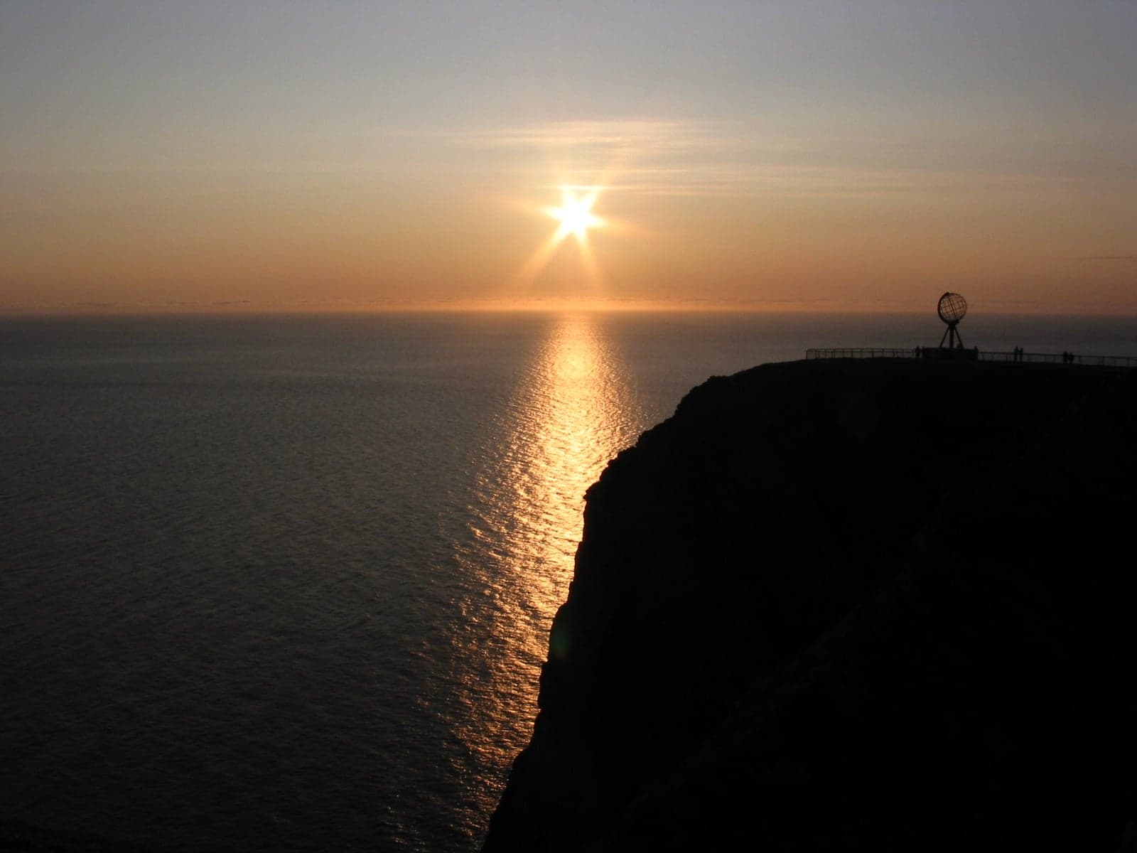 The sun low on the horizon over the sea at midnight in northern Scandinavia
