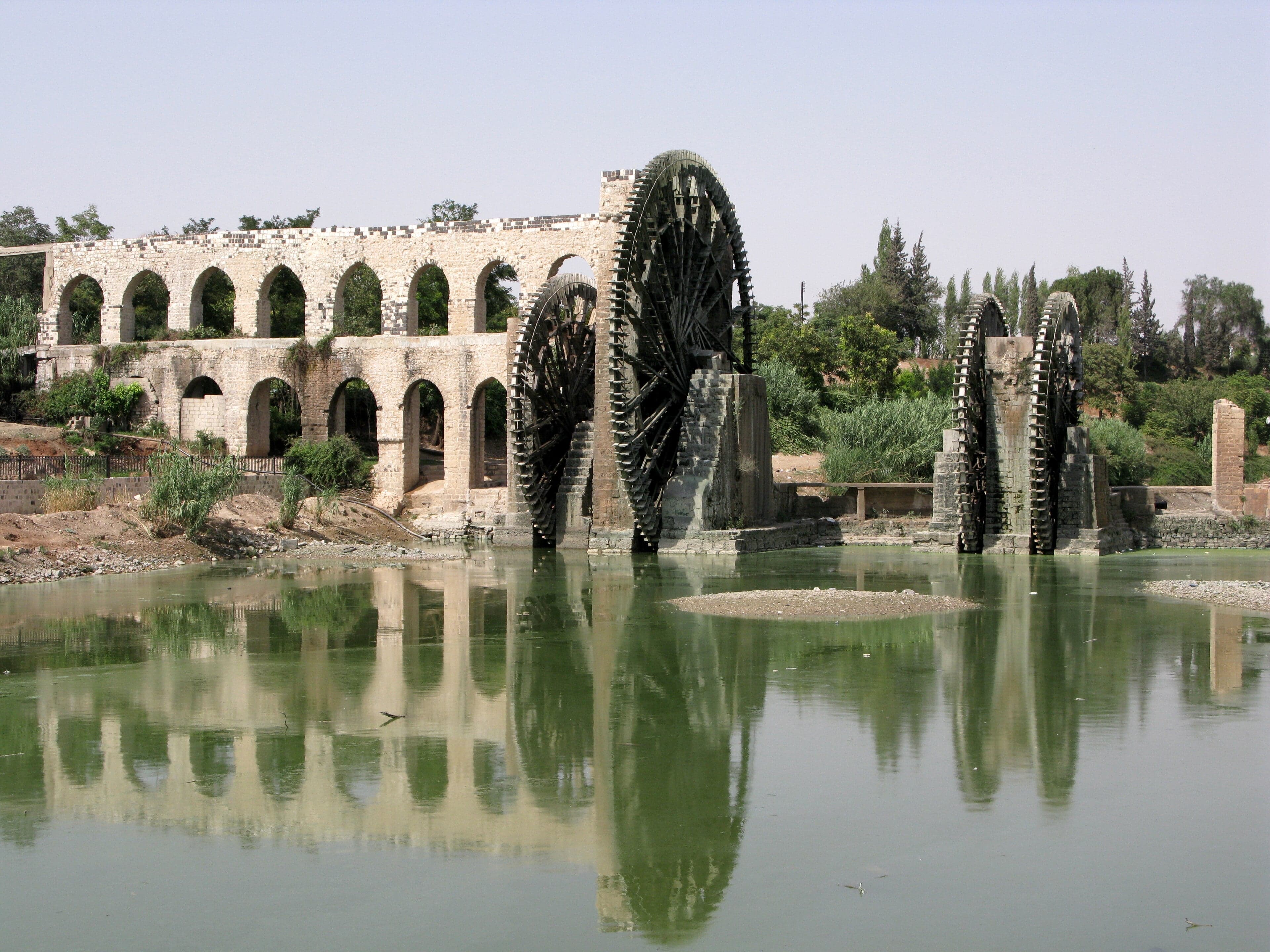 Large ancient wooden waterwheels turning in the Orontes River at Hama