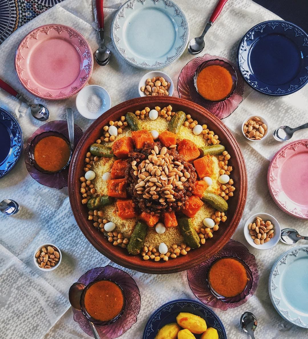 A large colourful bowl of Tunisian couscous topped with vegetables and sauce