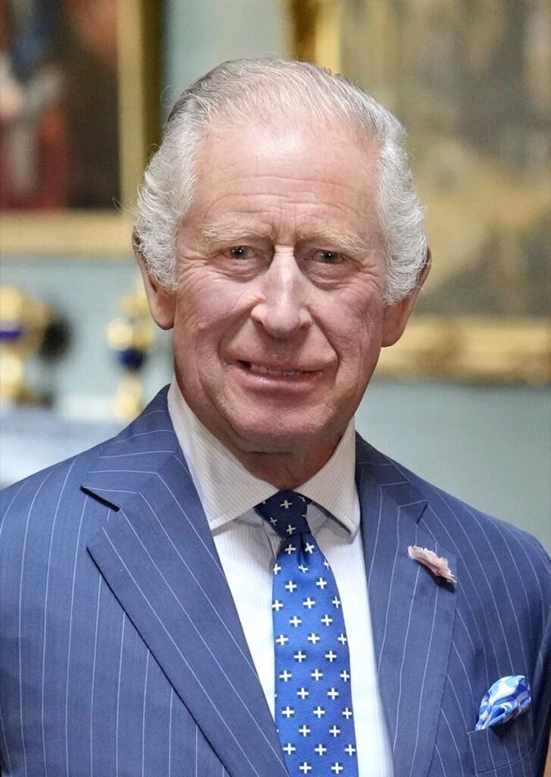 A portrait of King Charles III in a blue suit
