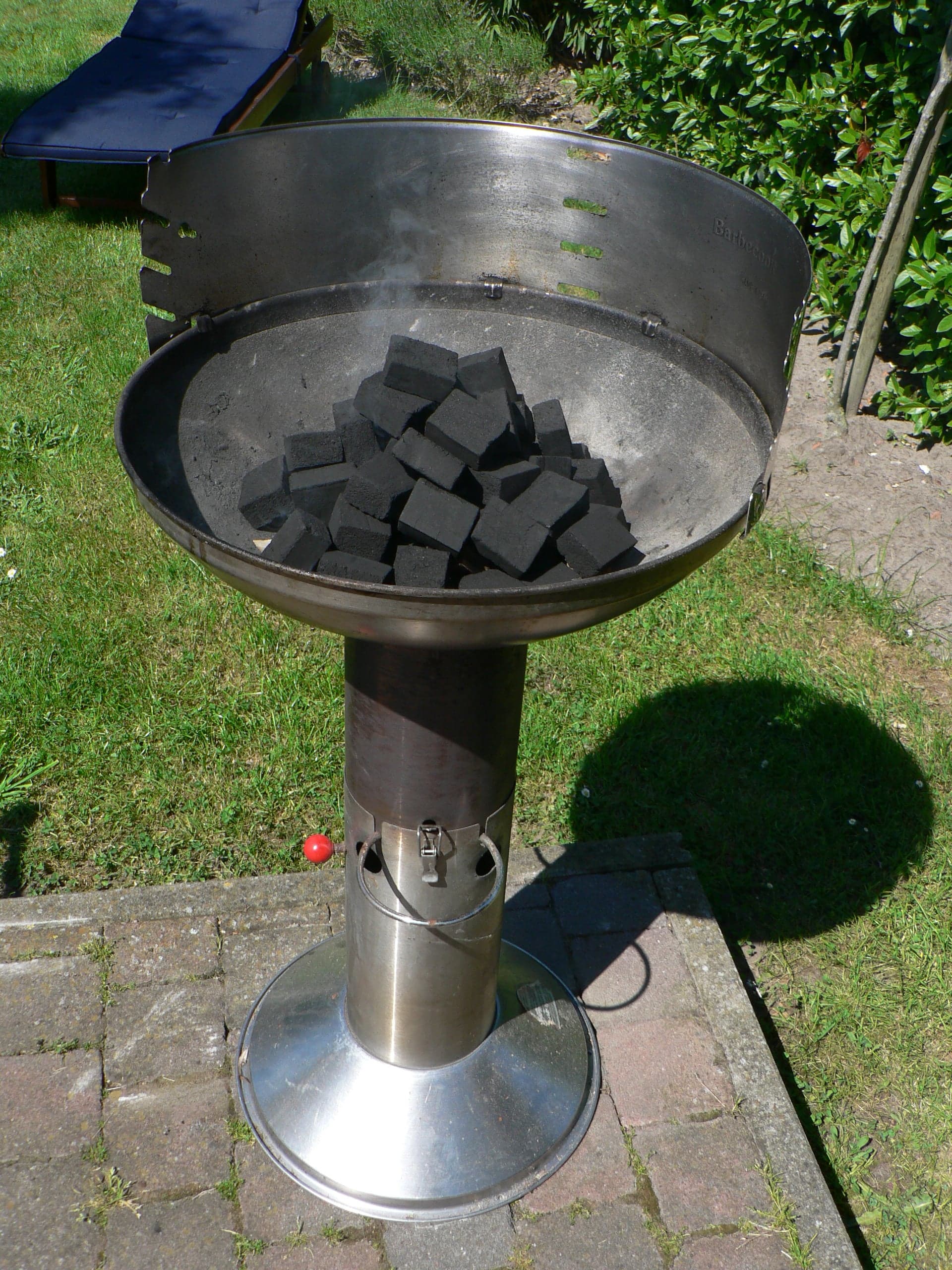 Ribs and sausages grilling over hot coals on a traditional Uruguayan parrilla