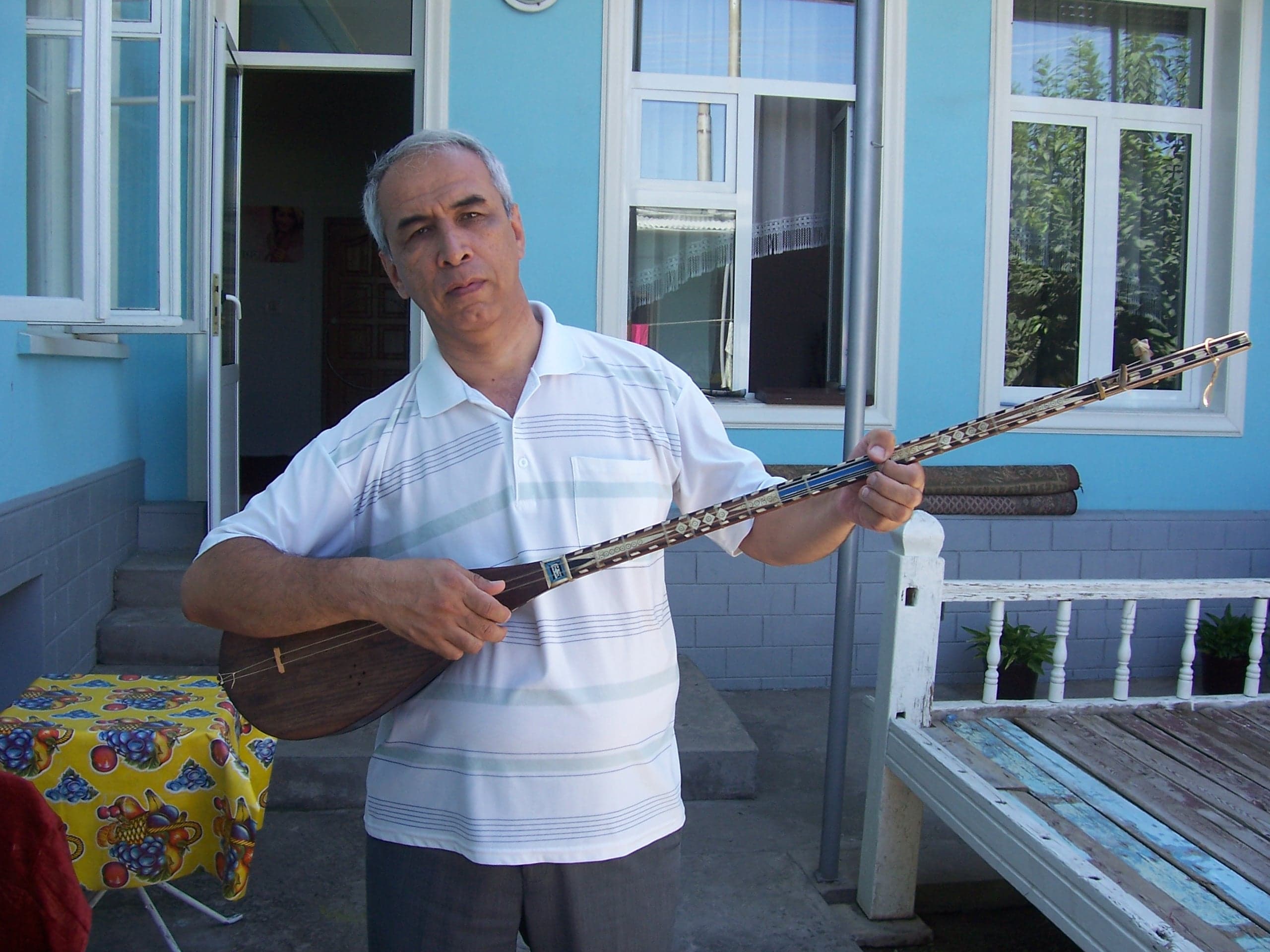A traditional wooden dutar lute with a long neck and a pear-shaped body