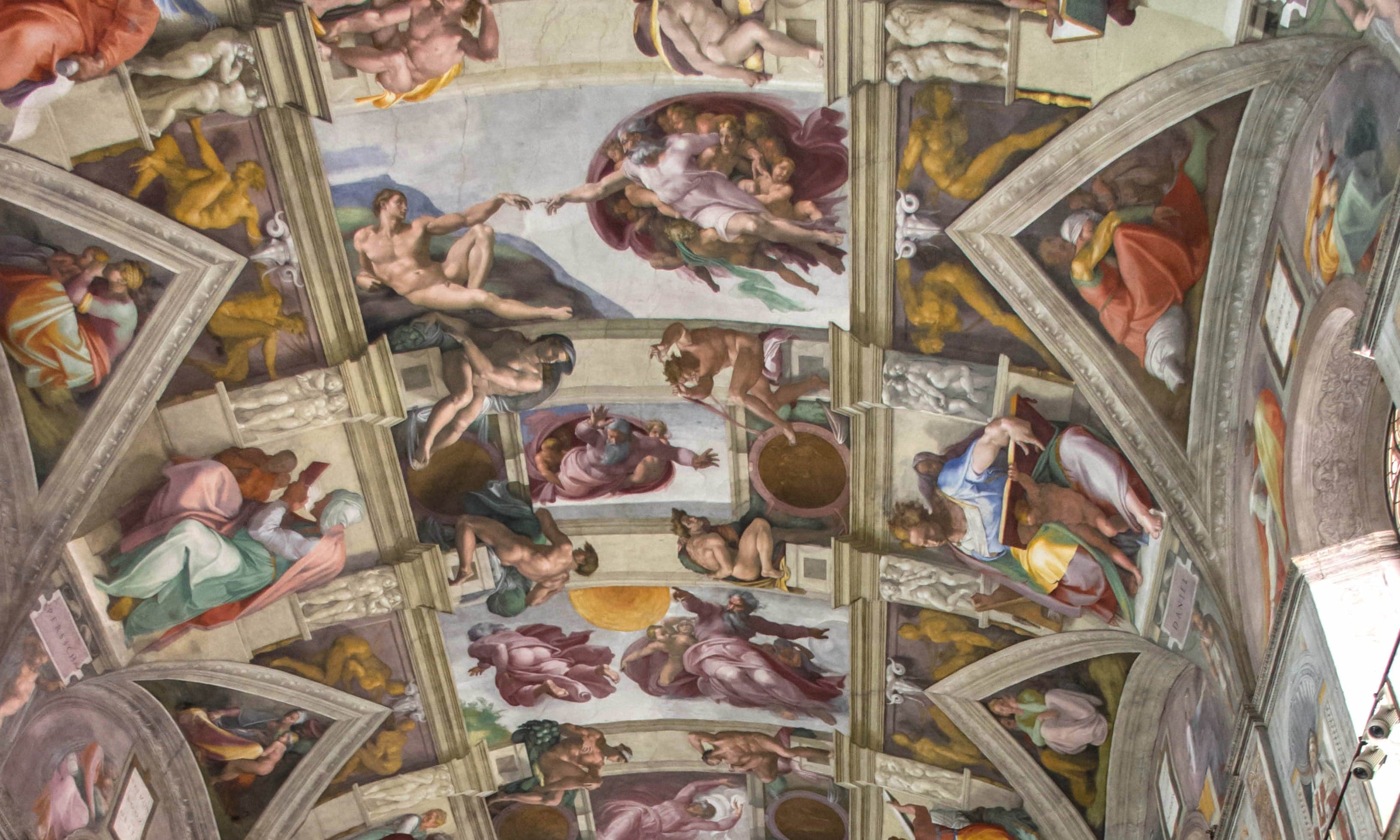 The painted ceiling of the Sistine Chapel showing vivid Renaissance frescoes
