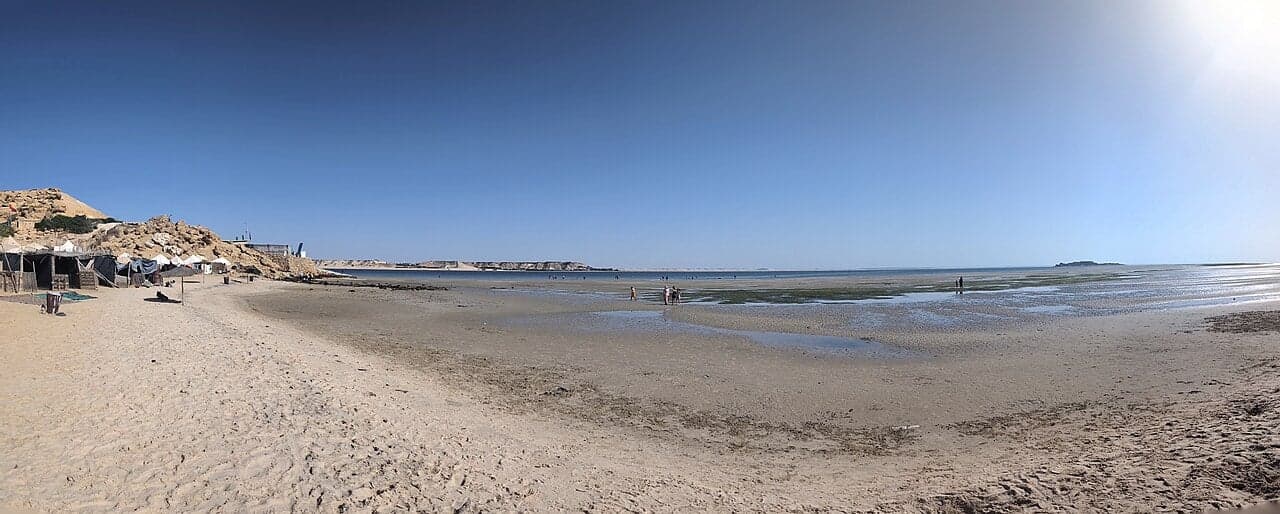 Kitesurfers on the flat turquoise lagoon at Dakhla peninsula