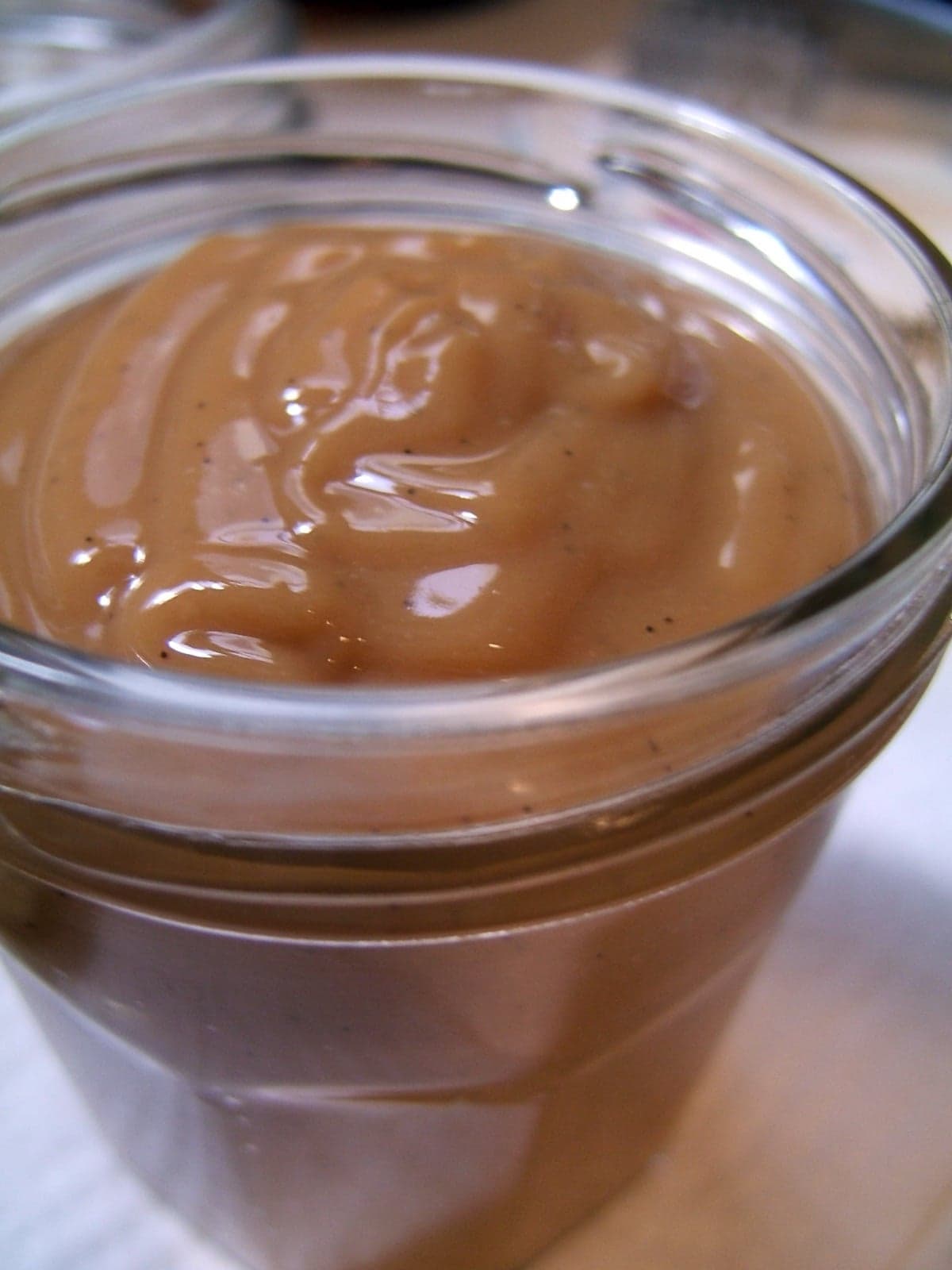 A jar of thick golden-brown dulce de leche caramel