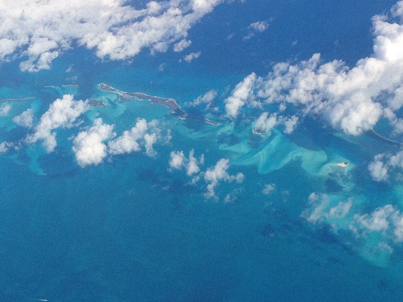 Aerial view of turquoise Bahamian waters with small green islands