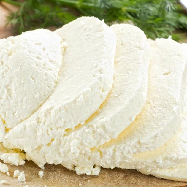 Rounds of fresh white wagasi cheese resting on a wooden board