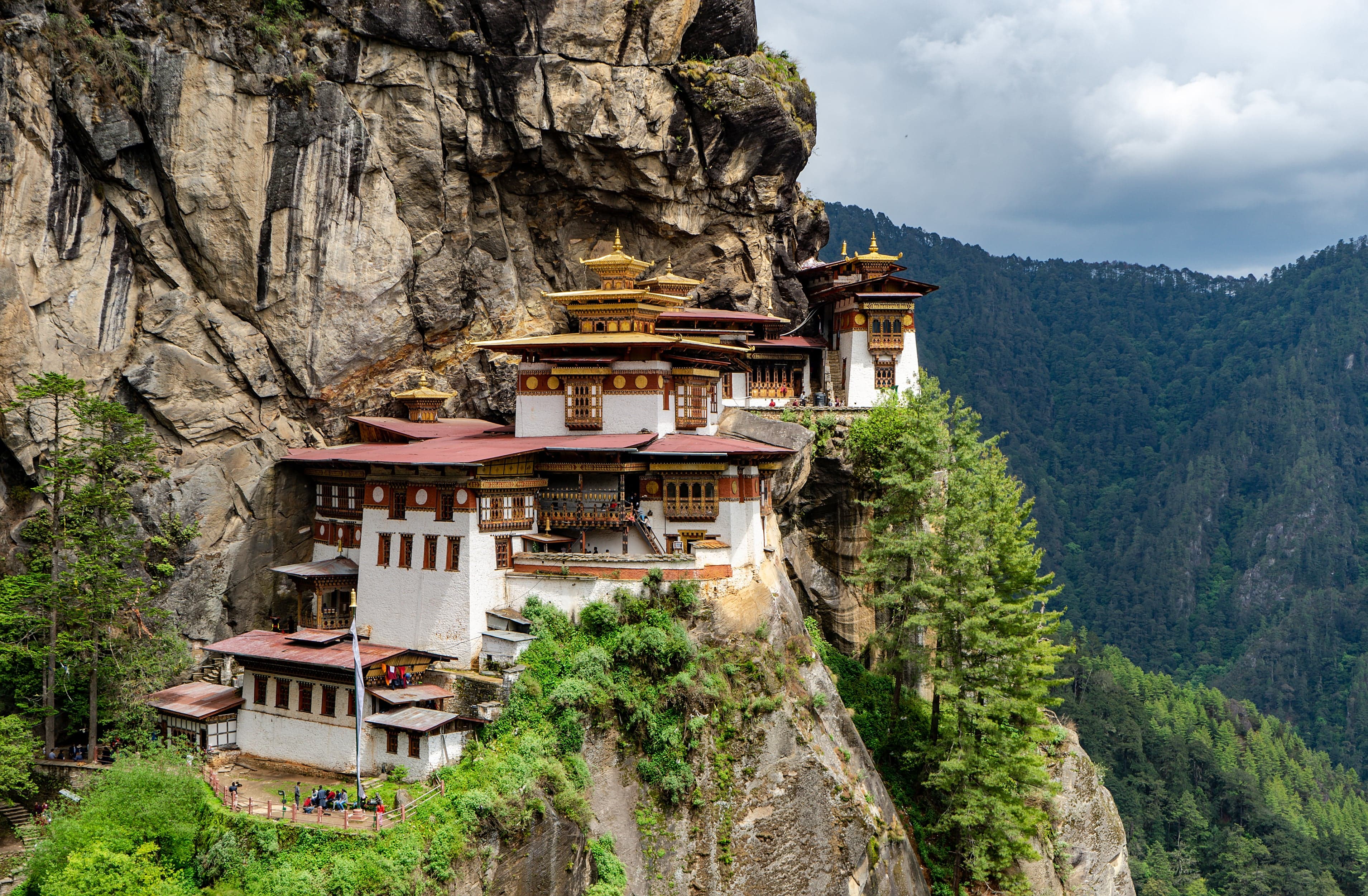 The white and gold Tiger's Nest monastery perched on a rocky cliff in Bhutan