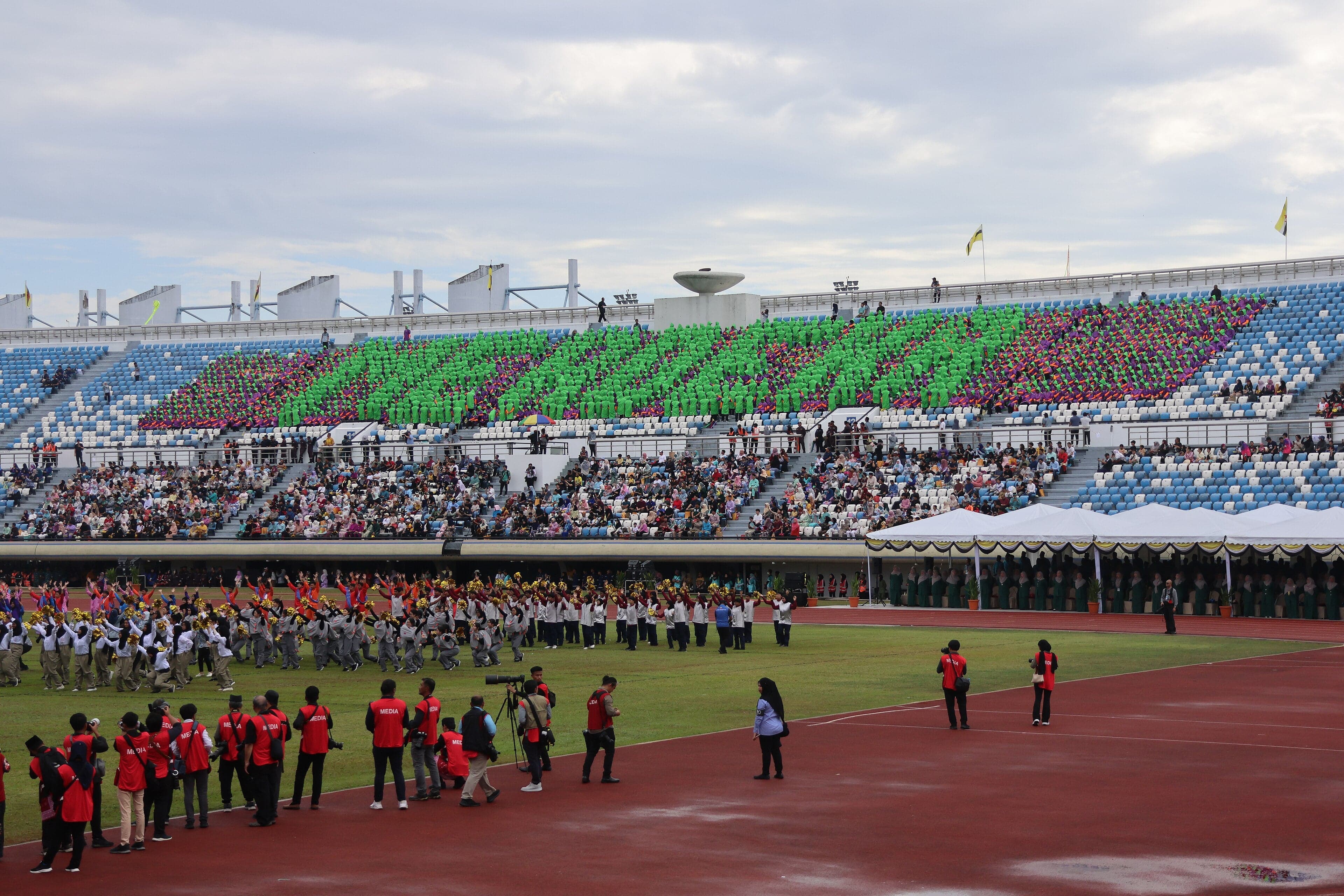 A colourful National Day parade with flag bearers and marching bands in Brunei