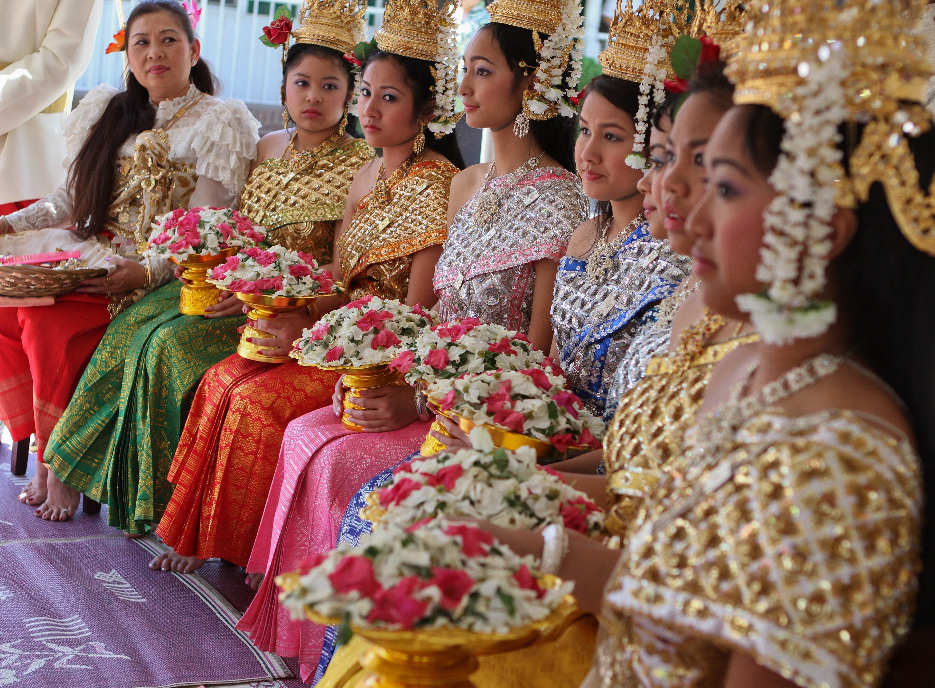People celebrating Khmer New Year by splashing water and playing traditional games
