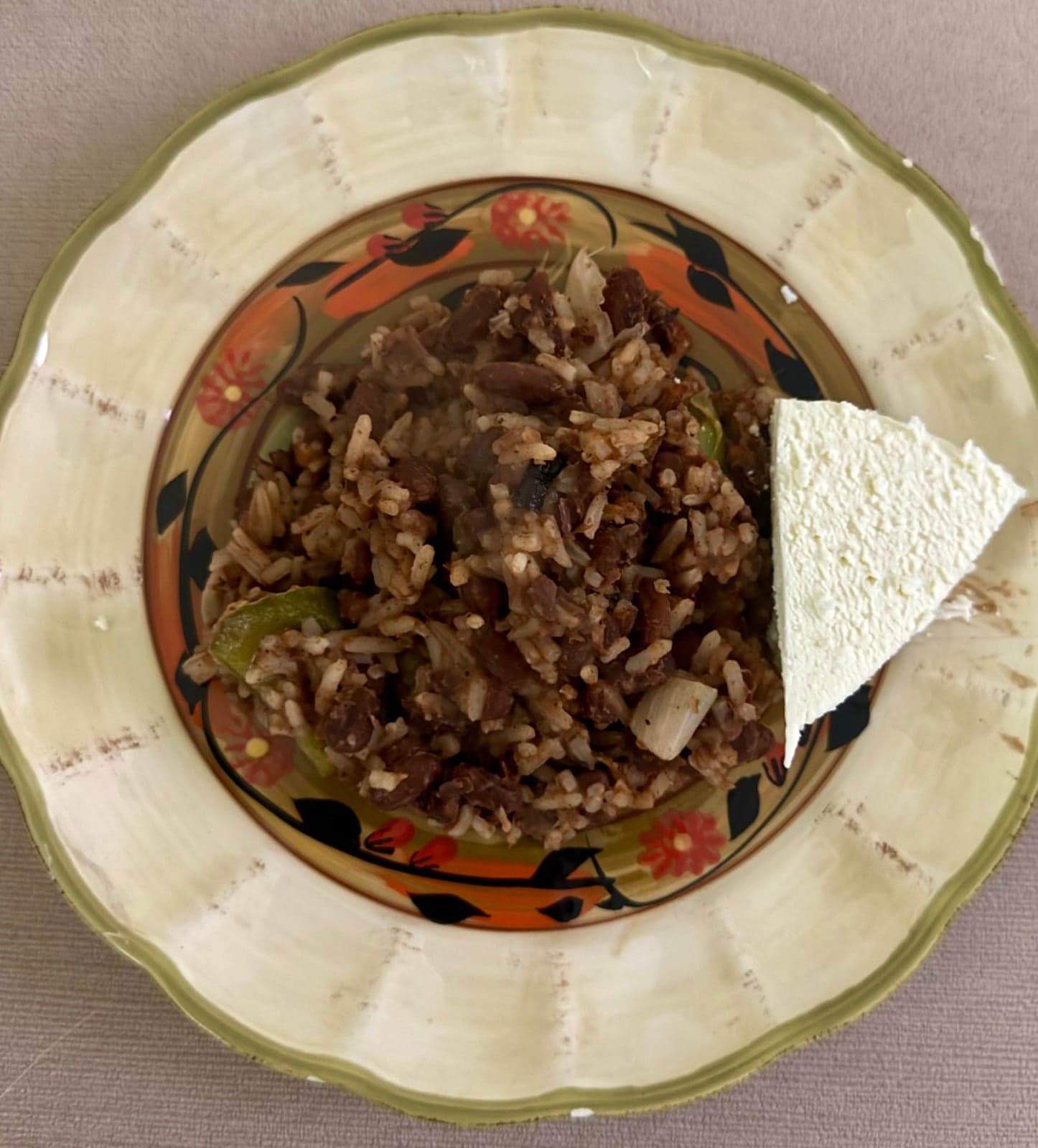 A plate of gallo pinto - speckled rice and beans - with fried egg and plantain