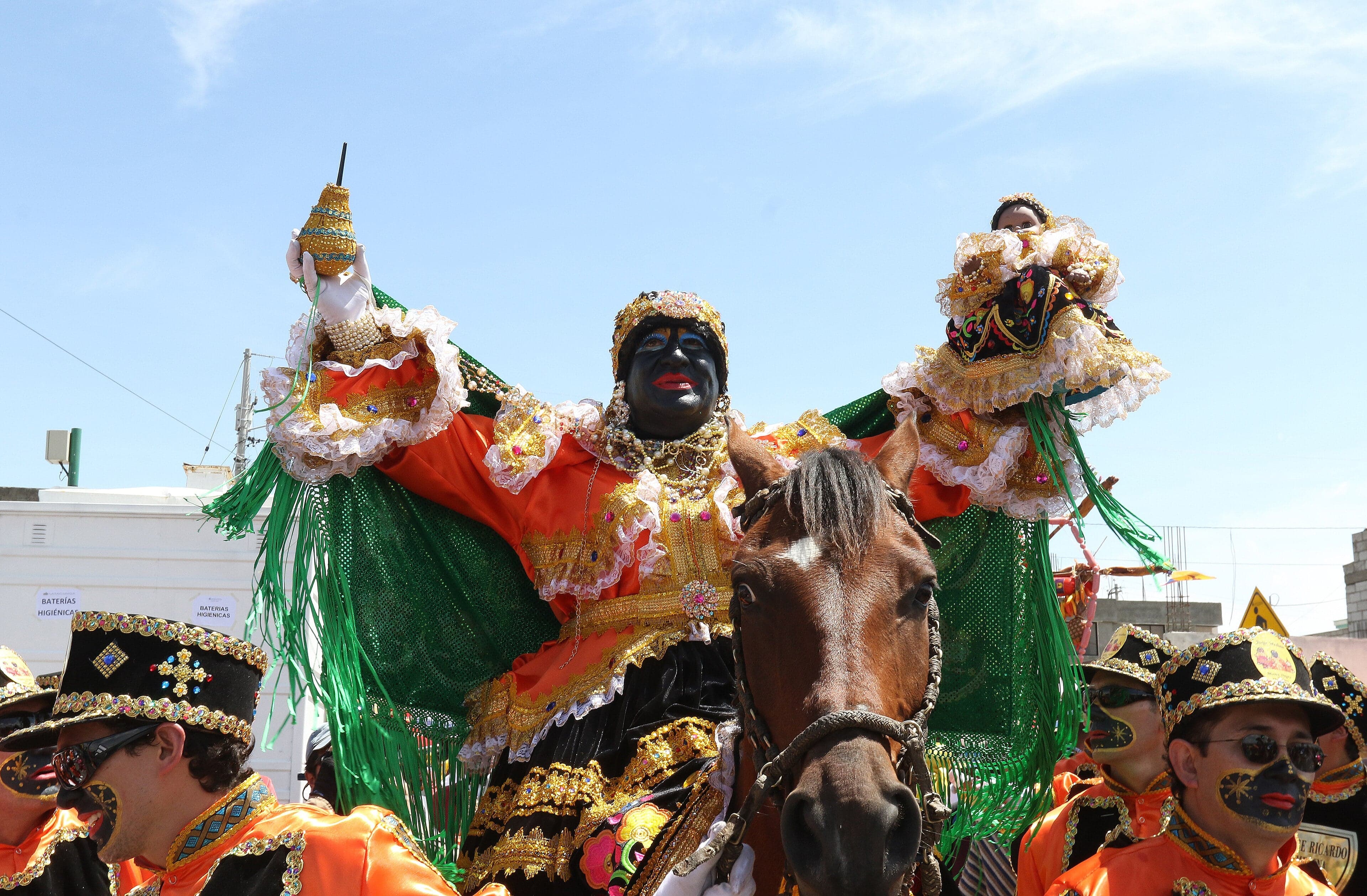 The Mama Negra figure in an elaborate costume at the heart of Latacunga's parade