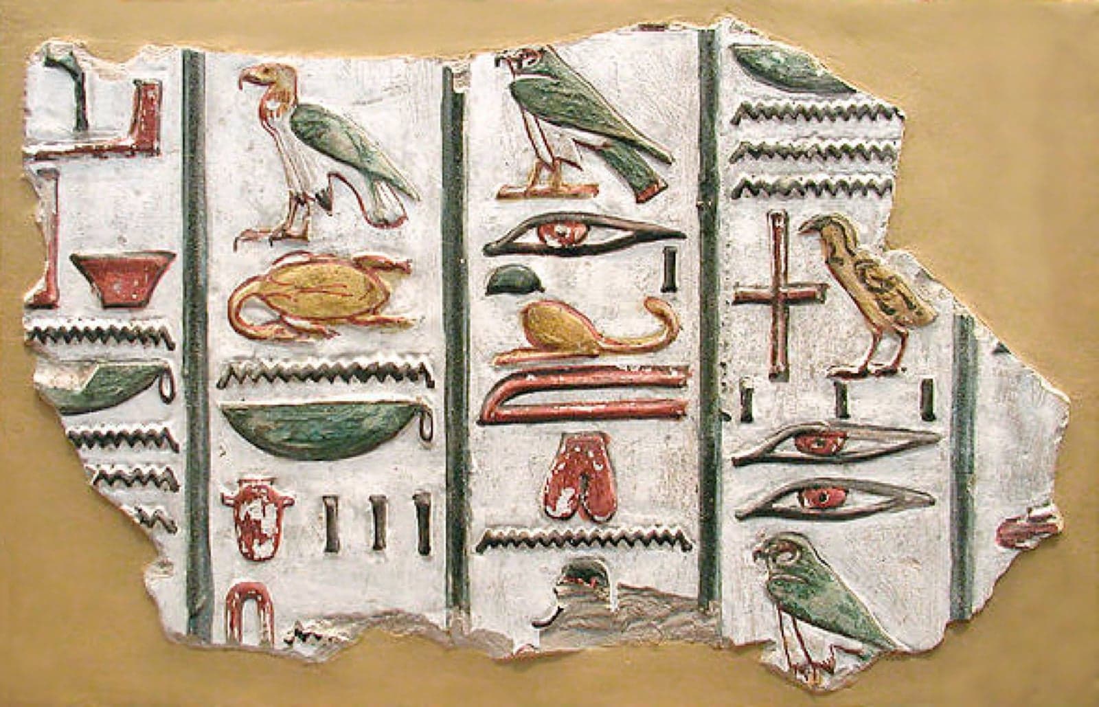 Colourful Egyptian hieroglyphs carved on a stone wall
