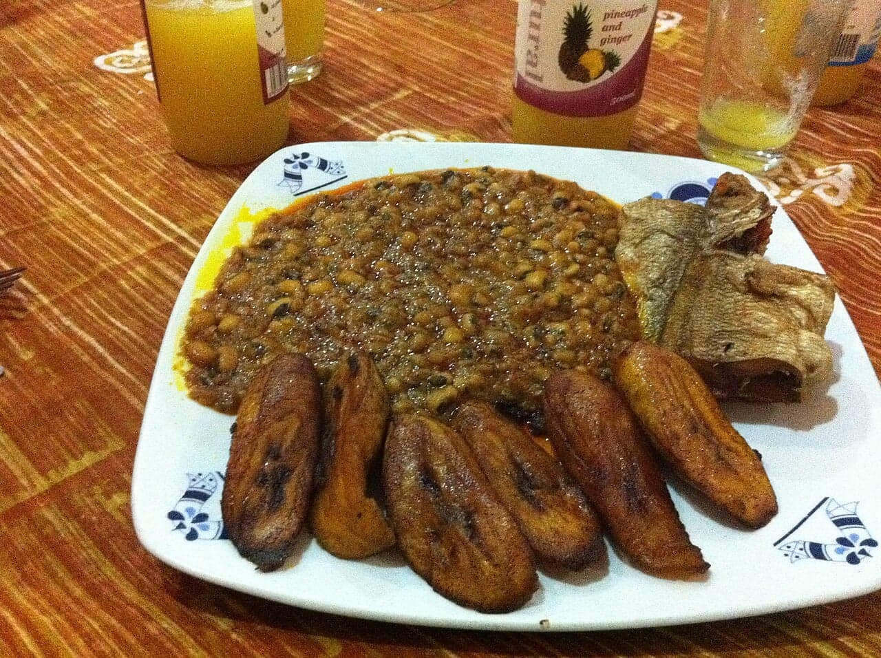 Slices of fried plantain golden and caramelised on a plate