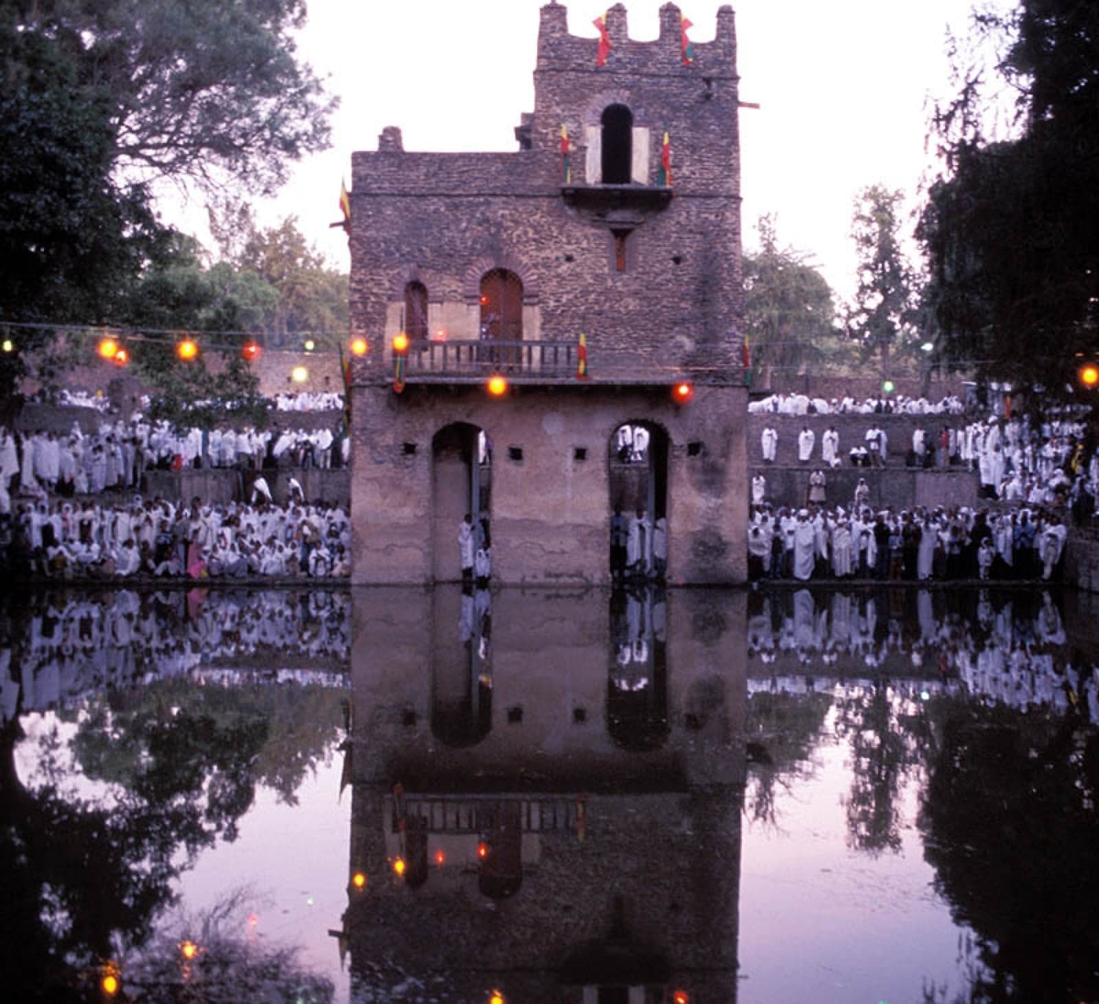 A Timkat procession in Ethiopia with colourful umbrellas and white robes