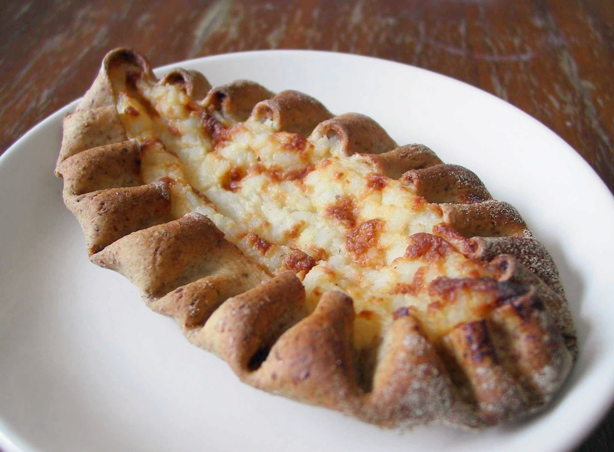 A traditional Finnish Karelian pie - a boat-shaped rye crust filled with creamy rice porridge