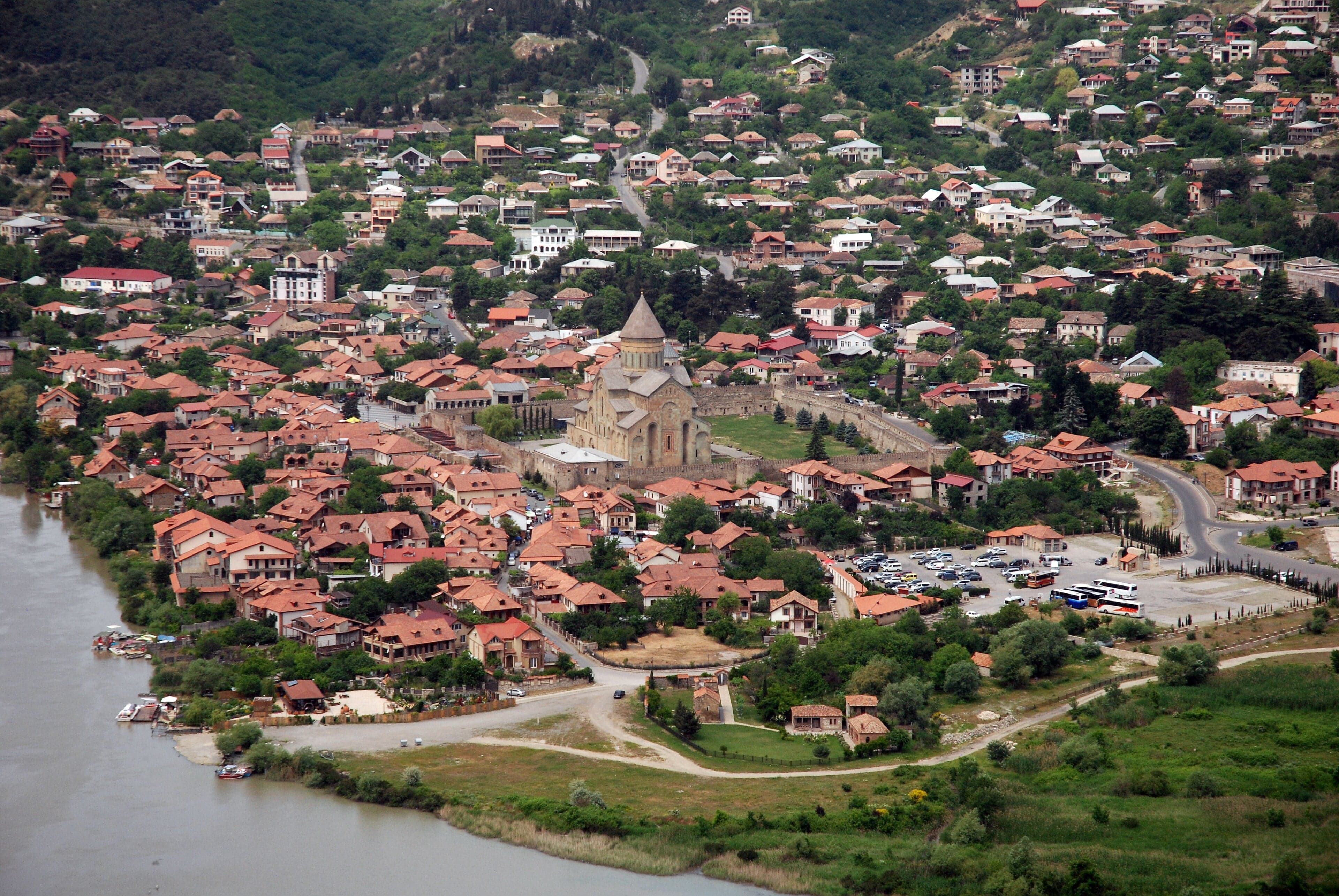 The Svetitskhoveli Cathedral in Mtskheta with mountains and a river visible behind