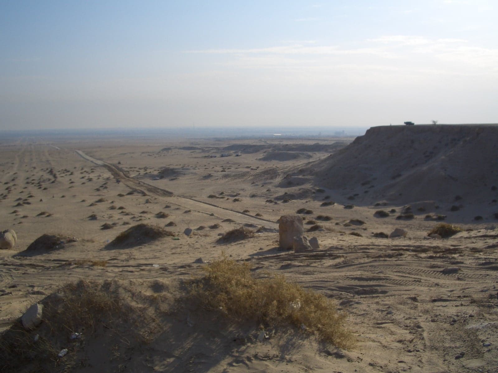 Rocky escarpment at Mutla Ridge overlooking a flat sandy Kuwaiti landscape