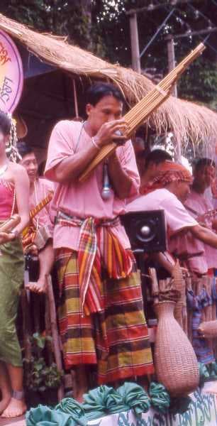 A musician playing a khaen mouth-organ made from bamboo pipes at a traditional Lao festival