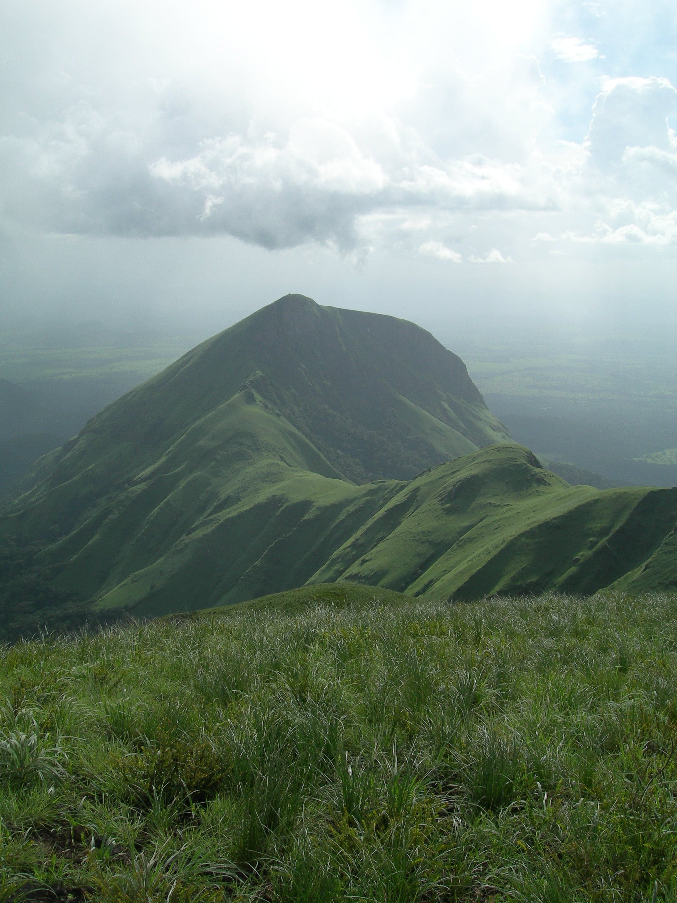 Rolling green slopes of Mount Nimba rising above the surrounding landscape