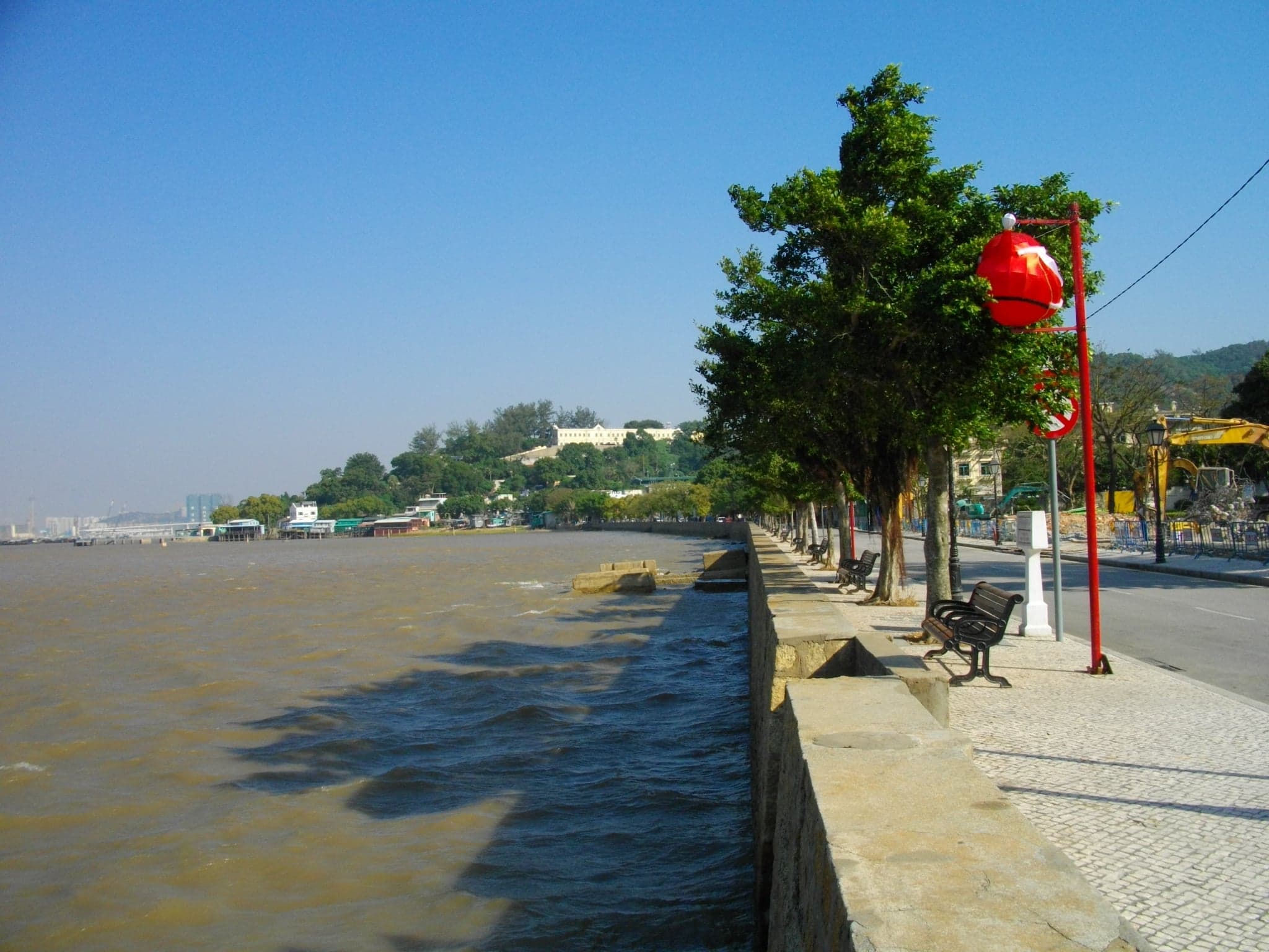 Lush green hills and a sandy cove on Coloane Island in Macau