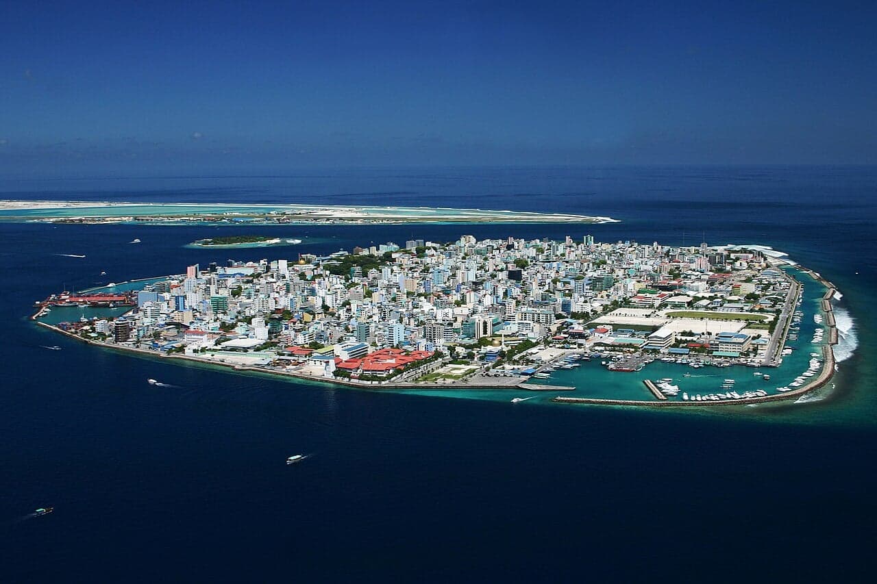 Colourful buildings and boats crowding the waterfront of Malé city