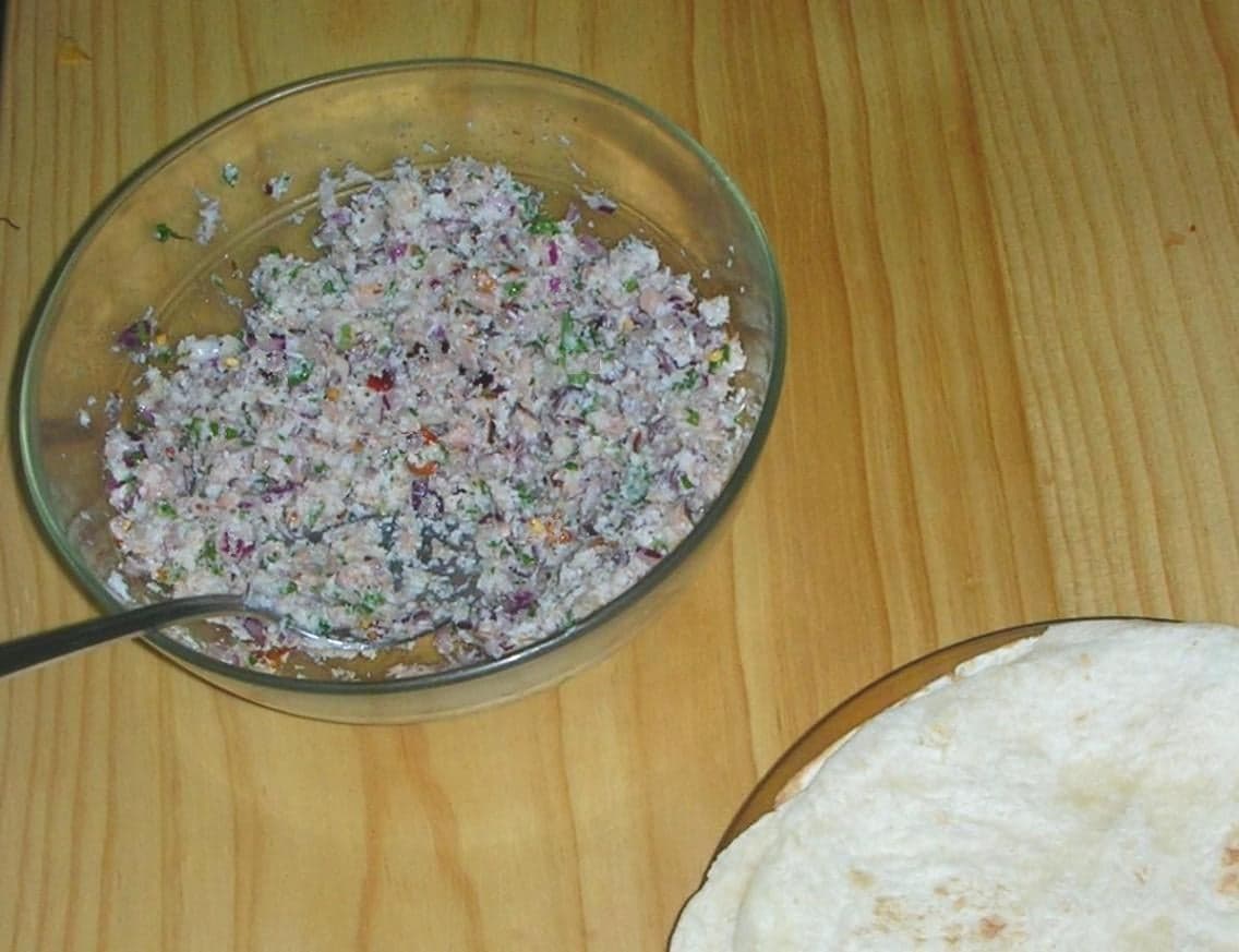 A plate of mas huni - shredded tuna mixed with grated coconut and onion