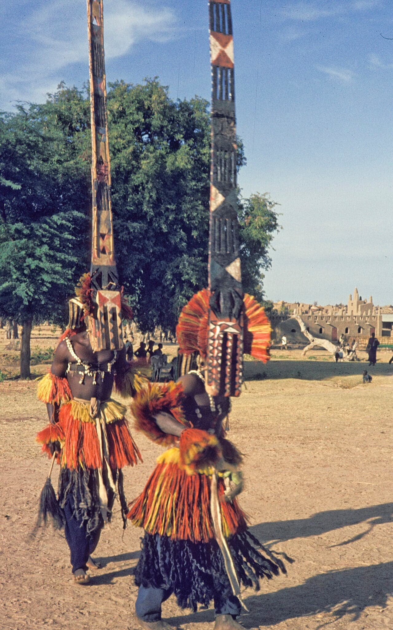 Dogon dancers in tall wooden masks and colourful costumes performing the Sigui dance in Bandiagara