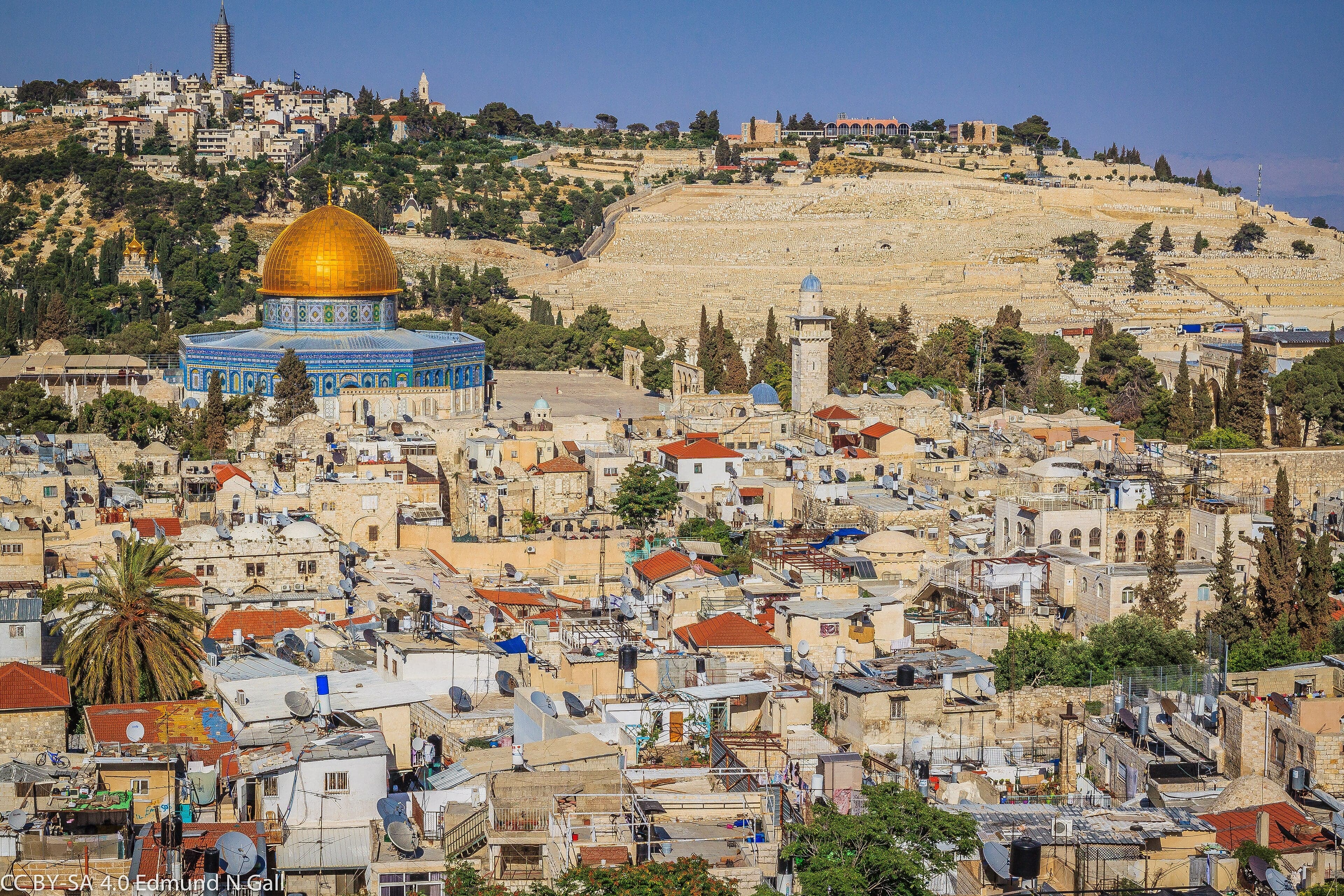 Stone walls and golden domes of the Old City of Jerusalem at sunrise