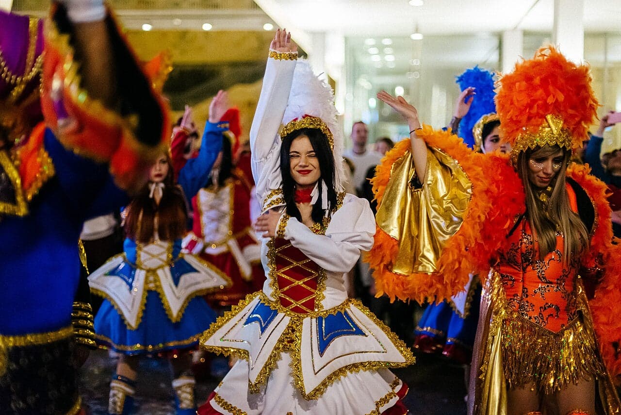 Carnival performers in enormous, spectacular feathered and sequinned costumes parading through the streets of Saint Lucia
