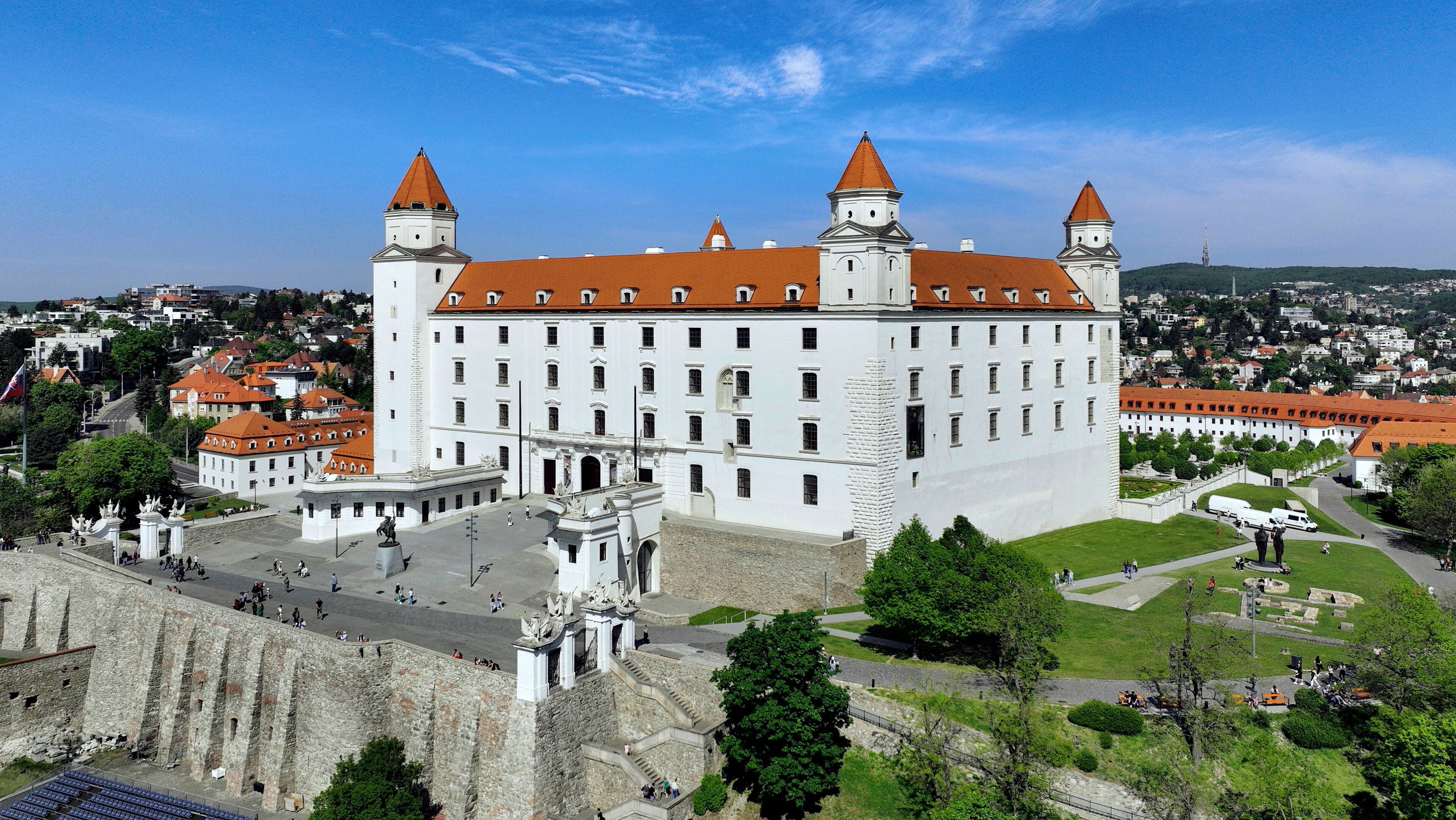 Bratislava Castle, a white rectangular castle with four corner towers, on a hill above the Danube River