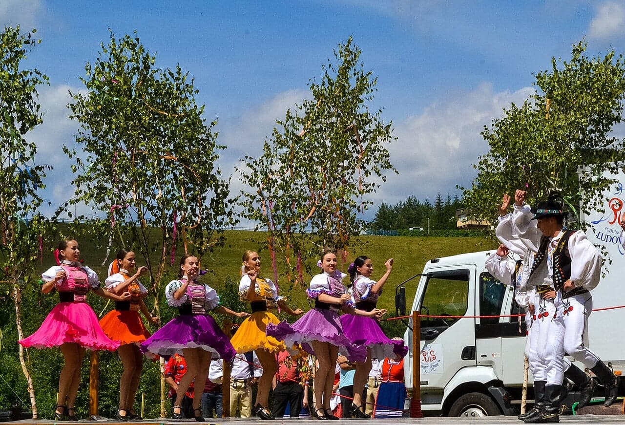 Slovak folk musicians playing fiddle and double bass in colourful traditional clothes