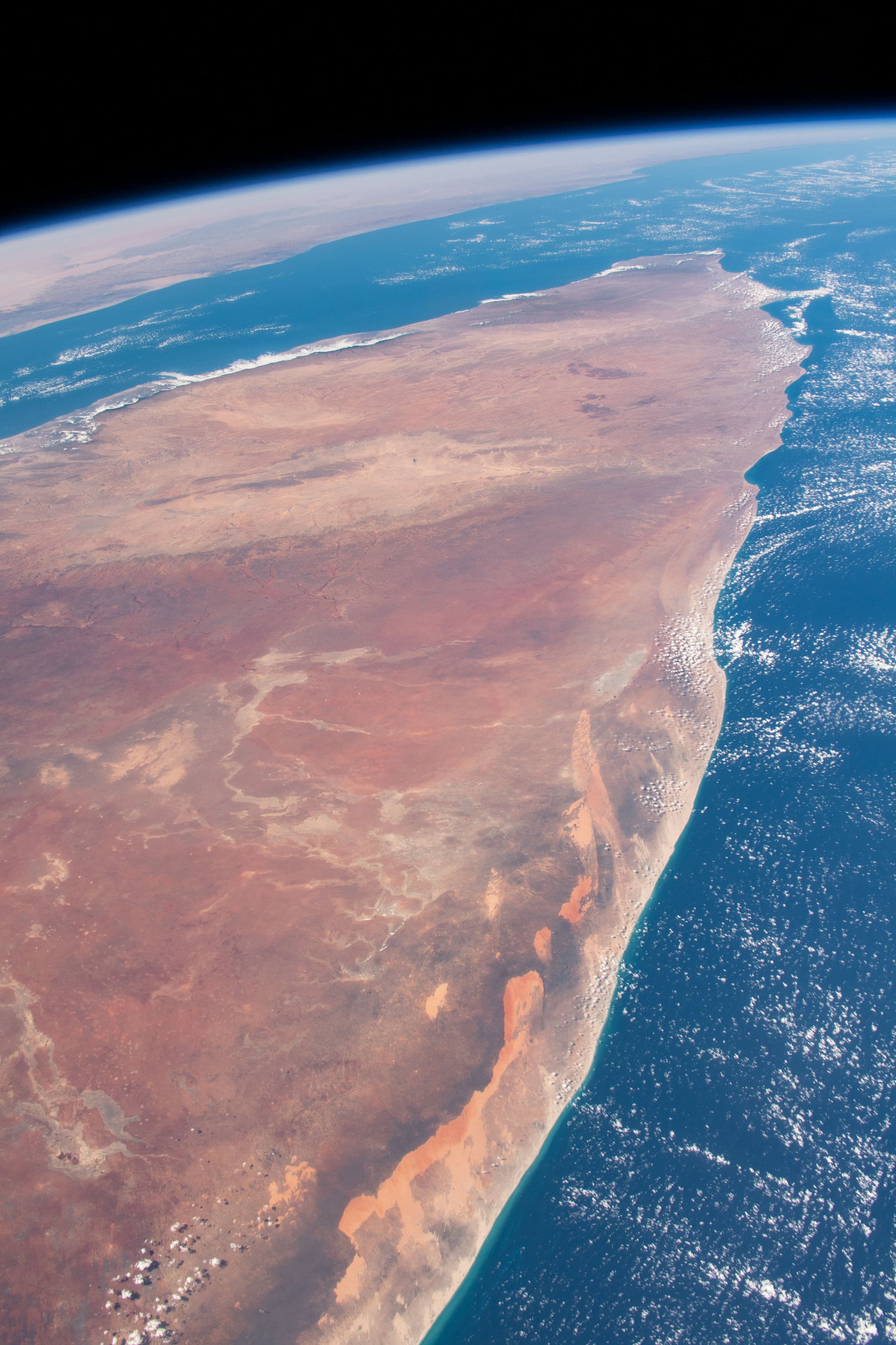 Turquoise Indian Ocean waves lapping a wide sandy beach in Somalia