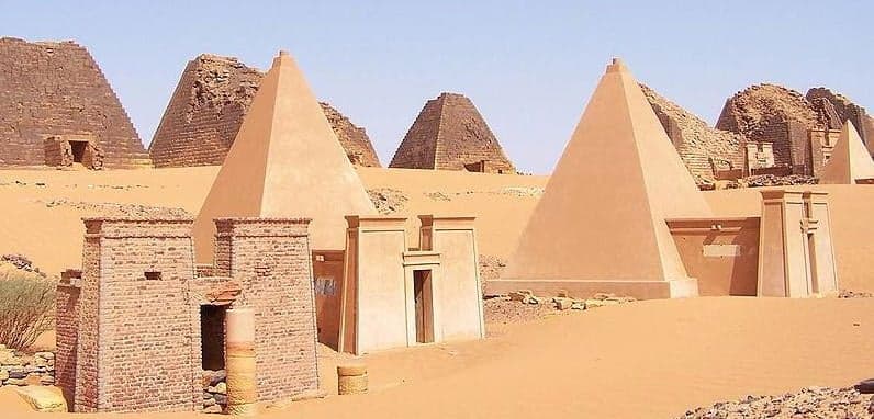 Rows of steep ancient pyramids rising from the desert sand at Meroë, Sudan