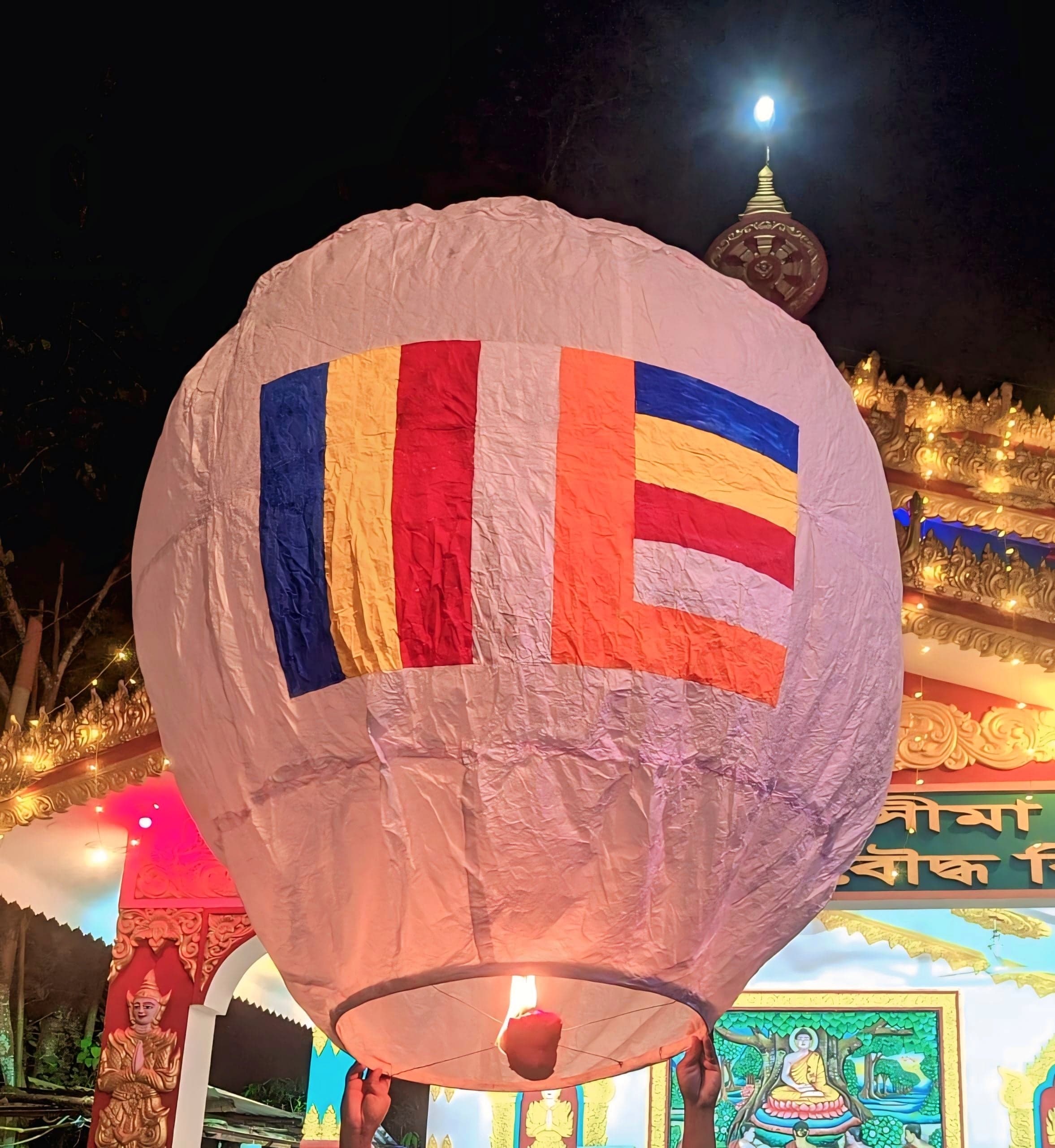 Glowing paper lanterns rising into the night sky over Pingxi