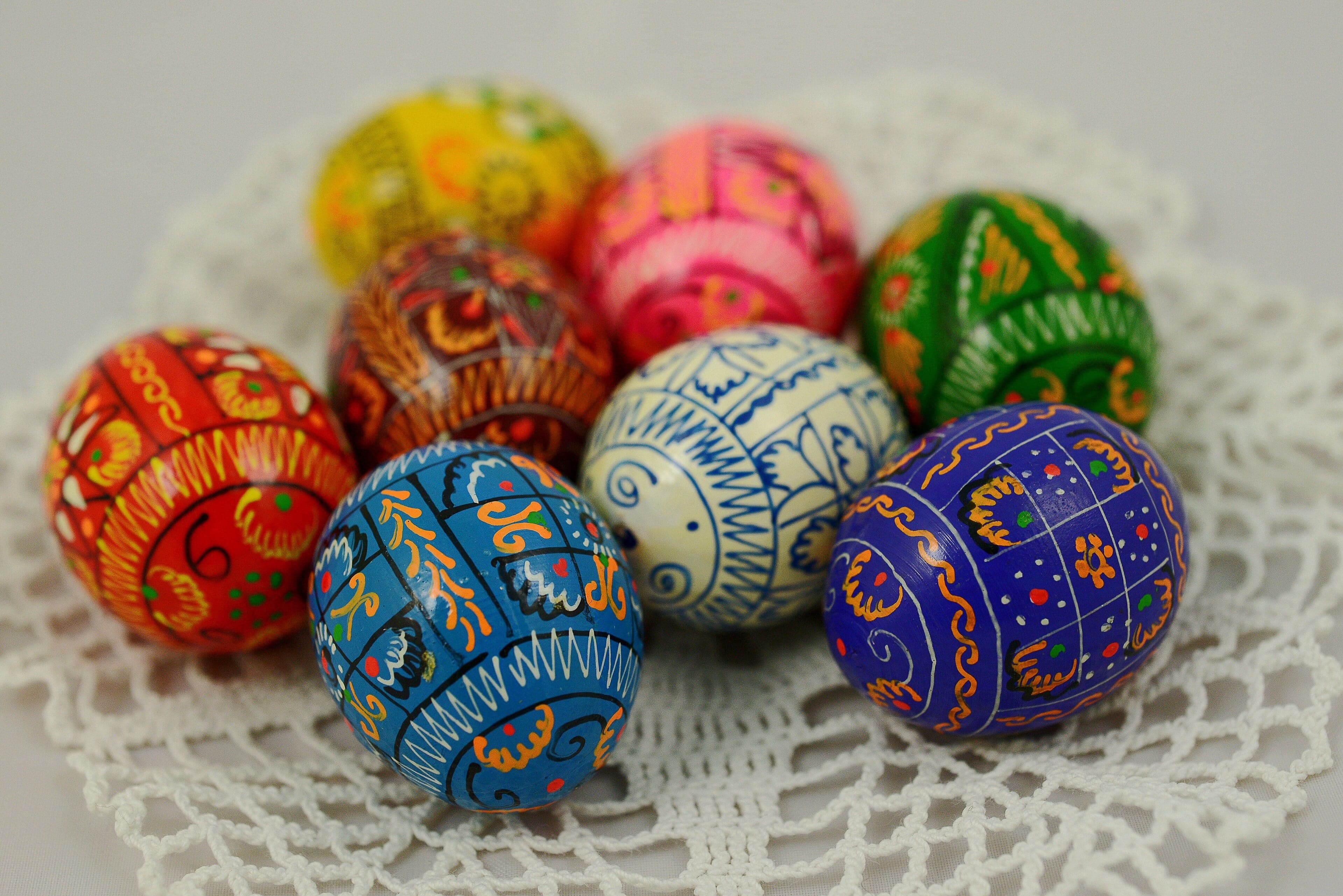 A basket of colourful pysanky eggs with detailed geometric patterns